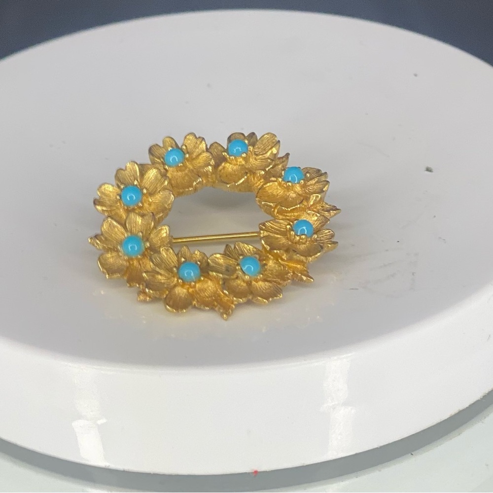 Gold colored with blue beads on leaves